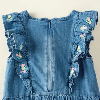 Back of blue denim romper with floral embroidered ruffle sleeves and center zipper