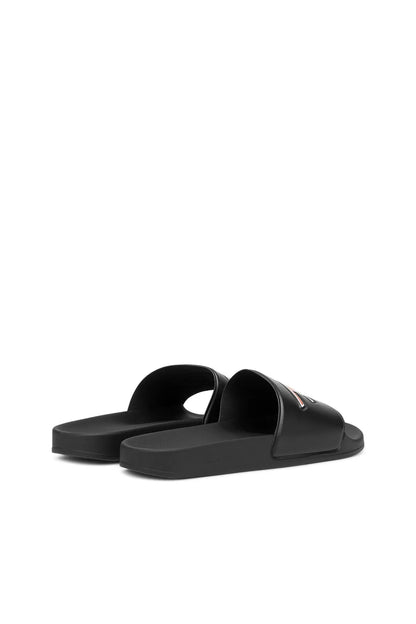 Black slide sandals pair with open toe and red/white AC logo on strap