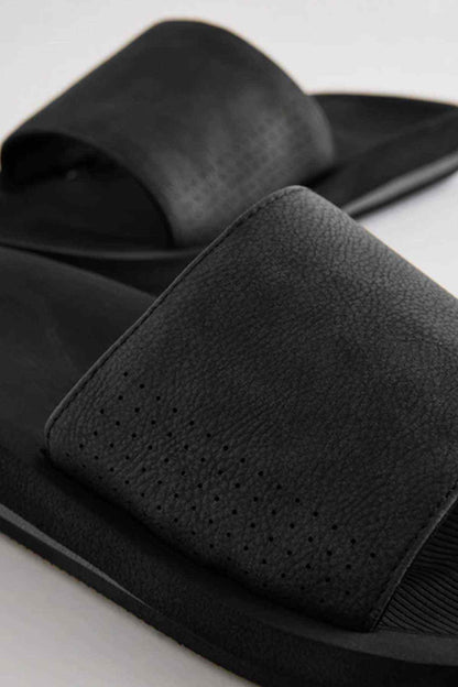 Black slide sandals with grainy strap and perforated front detail