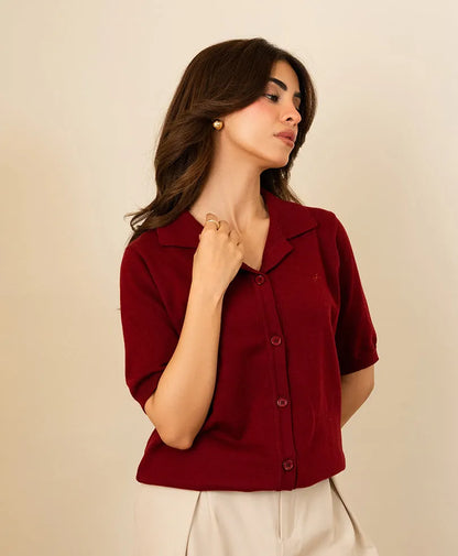 Fitted burgundy button-up shirt with short sleeves, pointed collar, and button placket
