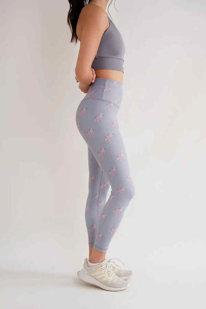 Grey sports bra and floral leggings set, side view, racerback sports bra