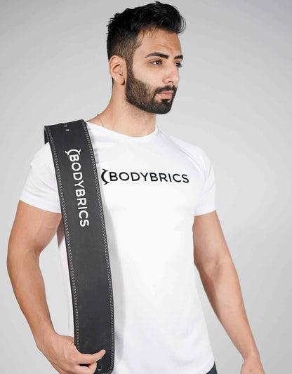 Black lifting belt held on shoulder, Bodybrics logo strip and stitched edges