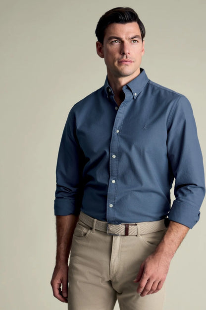 Blue long-sleeve dress shirt worn with beige trousers