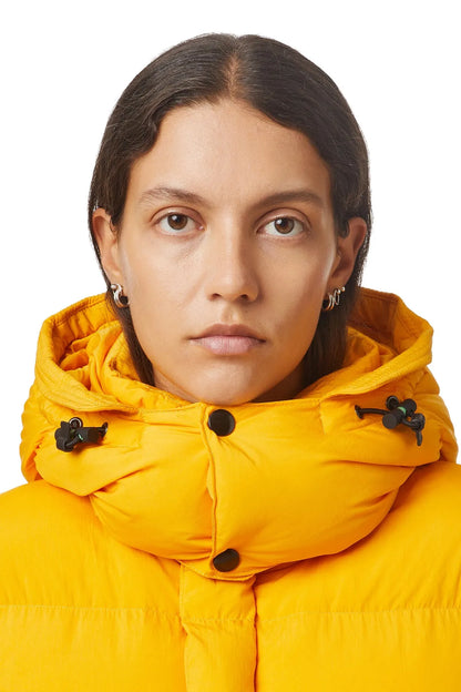 Diesel yellow puffer jacket hood with black drawstrings, close-up neckline