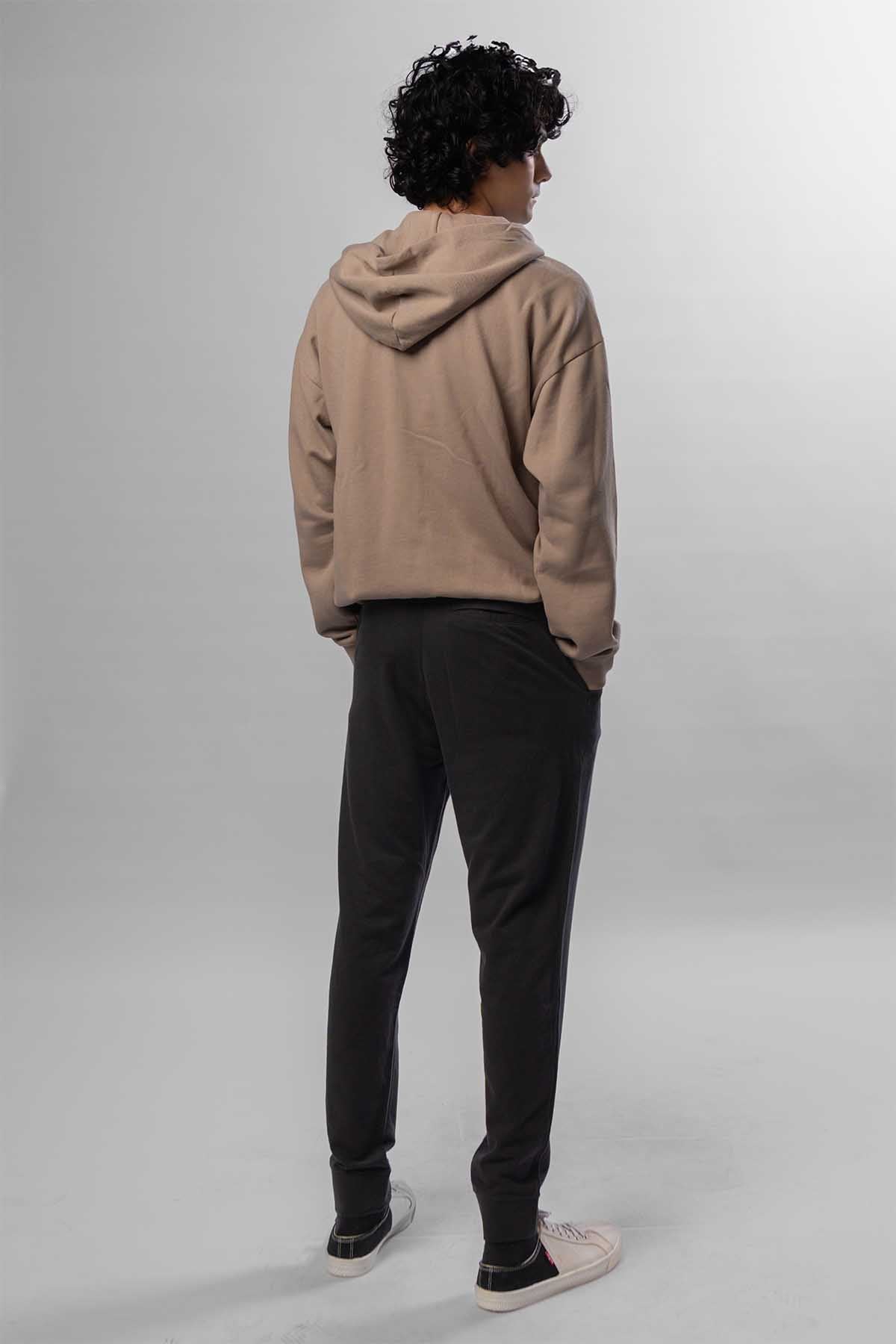 Men's taupe zip-front hoodie with hood, back view, worn with black jogger pants