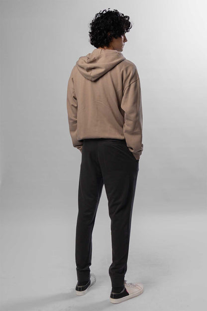 Men's taupe zip-front hoodie with hood, back view, worn with black jogger pants