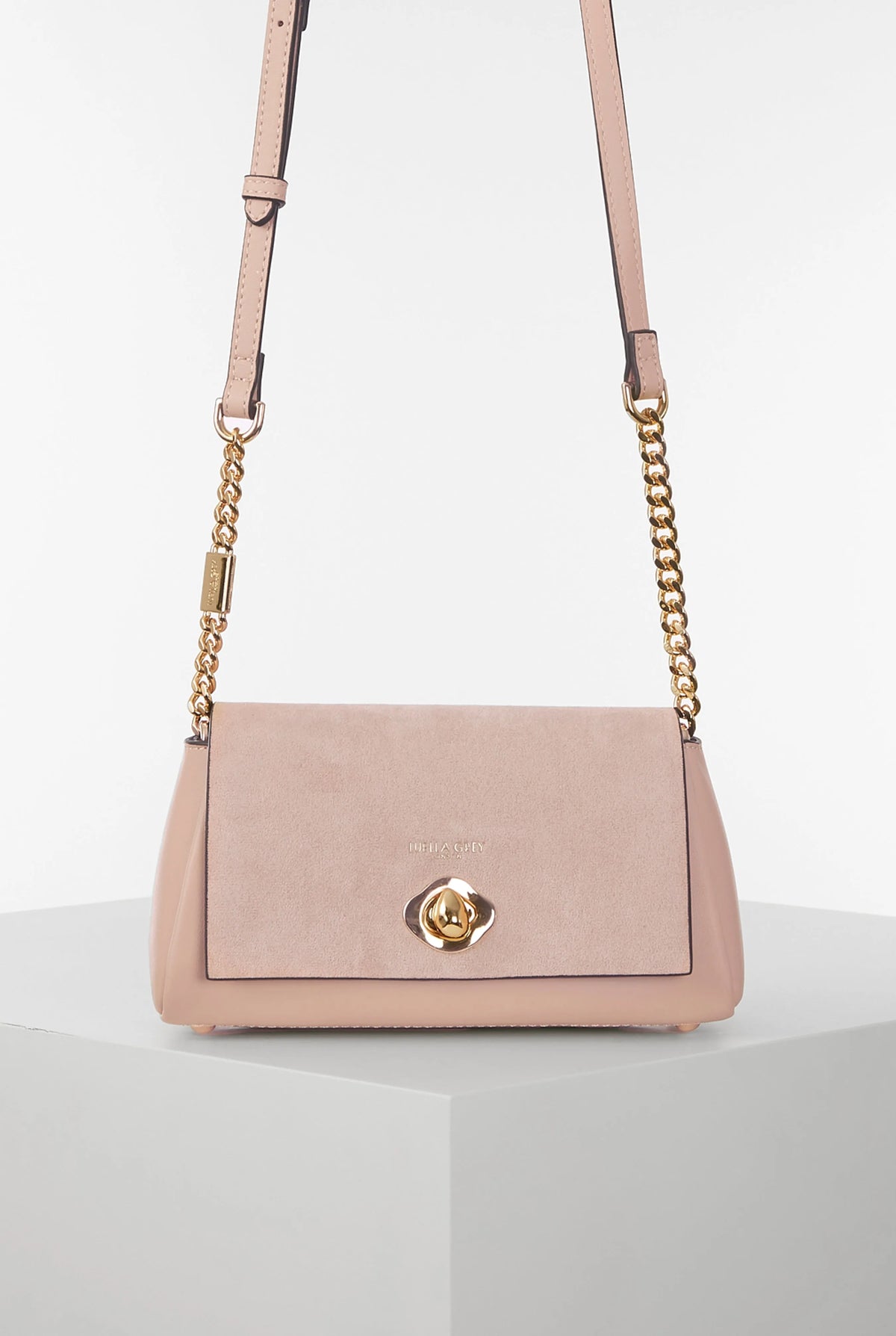 Pink suede-style shoulder bag with gold chain strap and front flap clasp