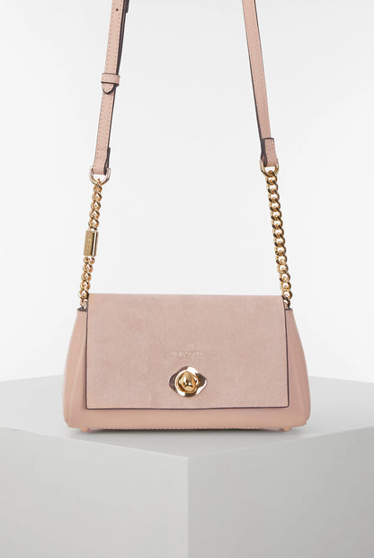 Pink suede-style shoulder bag with gold chain strap and front flap clasp