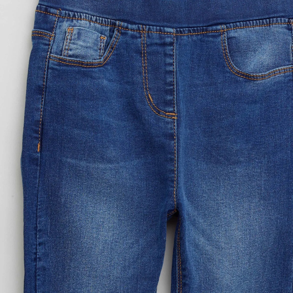 BABYSHOP blue denim jeans close-up: front pocket and orange stitch detail