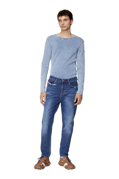Diesel blue denim jeans on model, straight-leg fit with belt loops