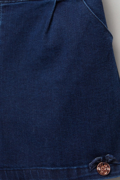 Close-up of navy denim baby shorts: stitched pockets and round logo button