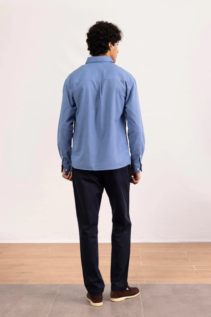 Men's blue button-up shirt back view with long sleeves and button placket