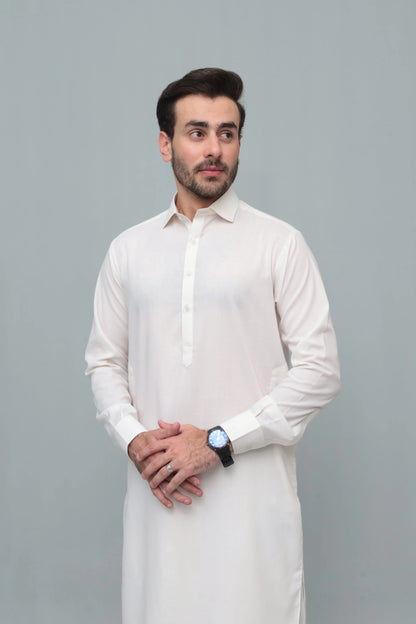Men's white shalwar suit with long buttoned kurta, close-up of chest and sleeves