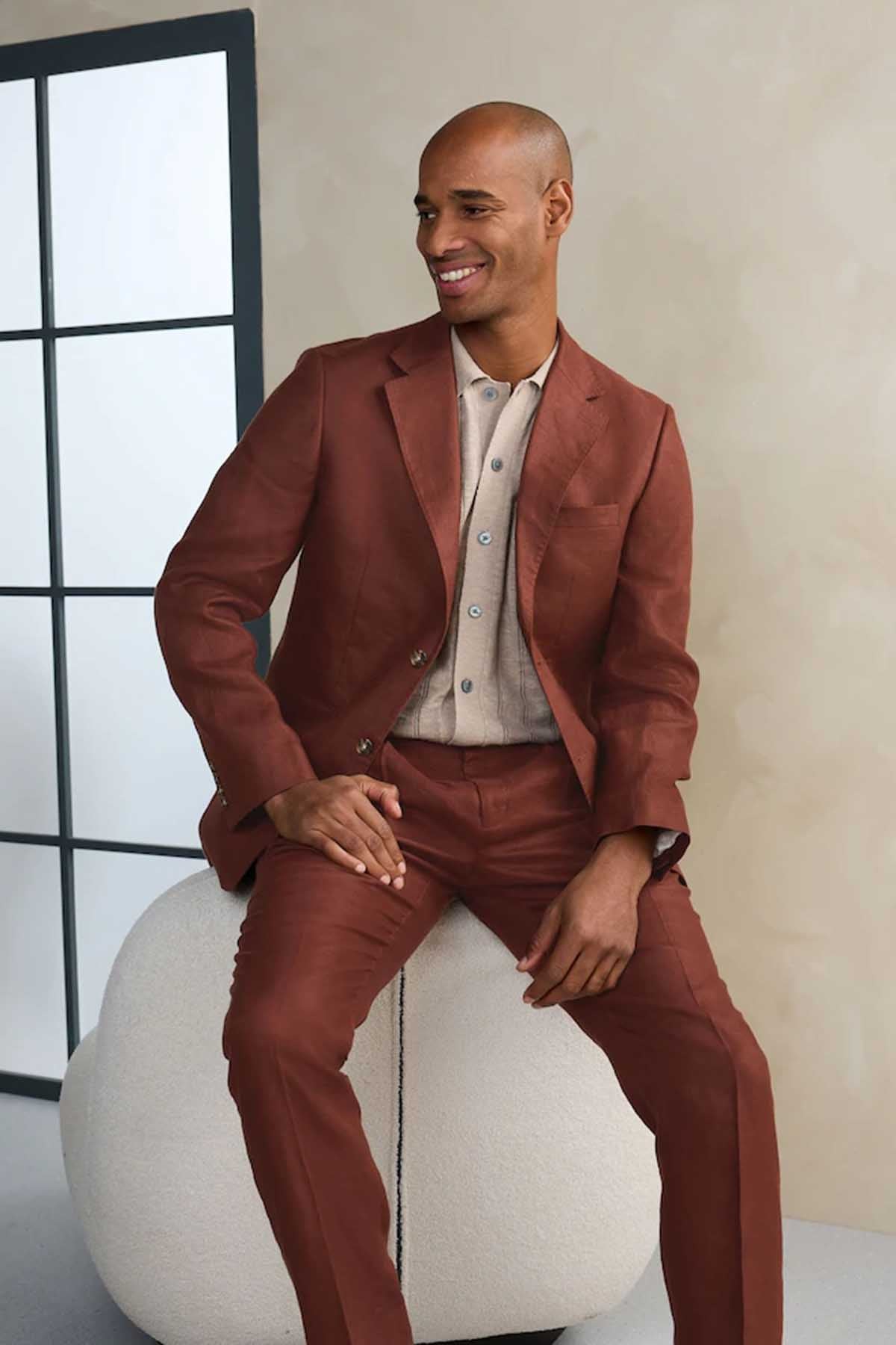 Brown three-piece suit with single-breasted jacket and vest, model seated