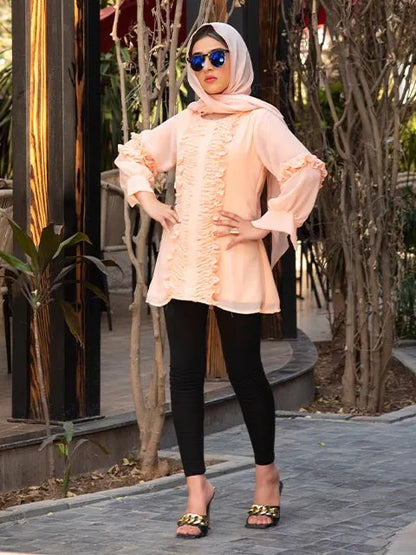 Peach tunic with ruffle-trim placket and cuffed sleeves, curved hem