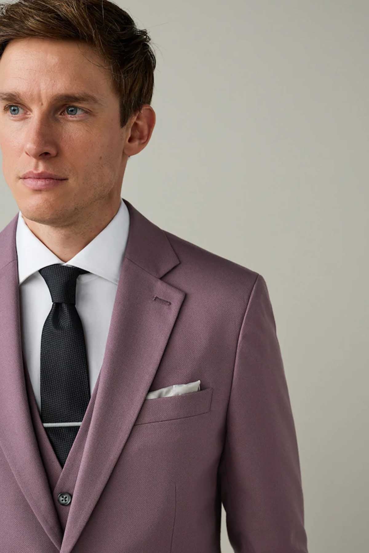 Lilac purple suit jacket lapels with pocket square and buttoned waistcoat