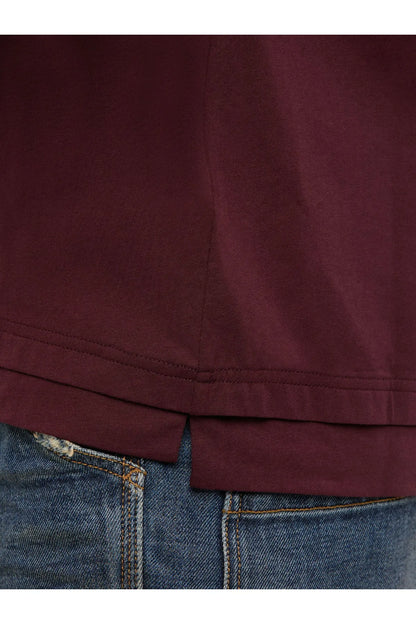 Diesel maroon T-shirt hem and side seam detail over blue denim jeans