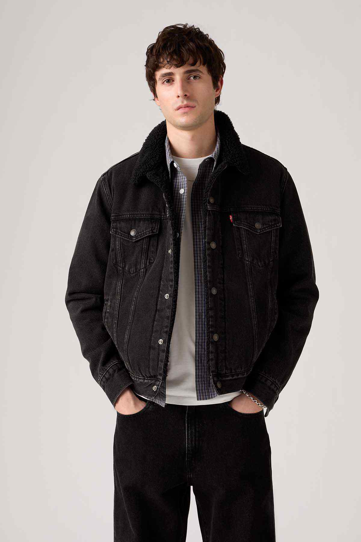 Levi's black denim jacket with button front, flap pockets, and dark lined collar