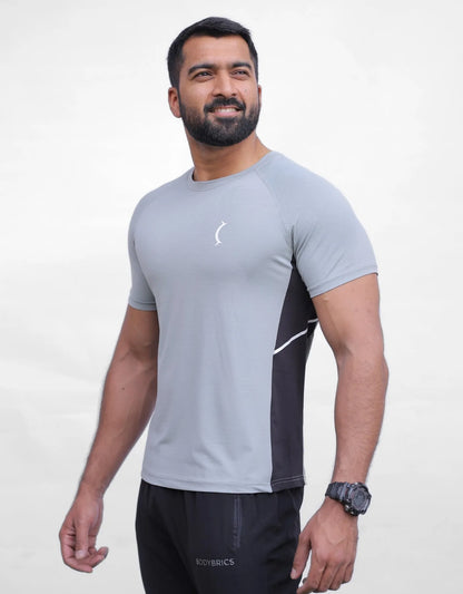 Men's athletic t-shirt in light gray with black side panels and small chest logo