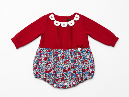 Red long-sleeve baby romper with white scalloped collar and blue floral shorts