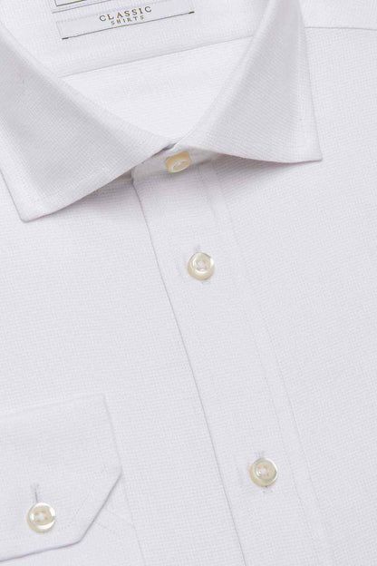 White dress shirt collar and top buttons with gold-tone studs
