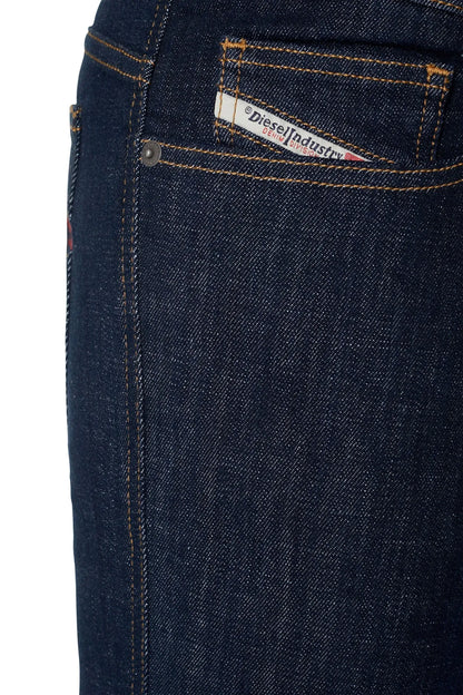 Denim jeans waistband pocket detail with stitched logo label and rivets.