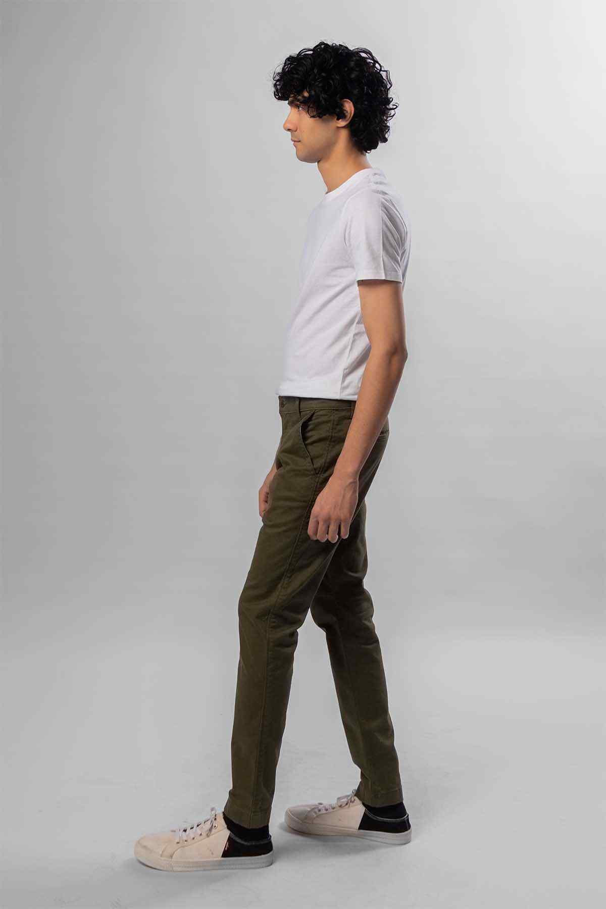Men's green pants in dark olive, side view with white T-shirt