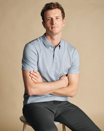 Light blue polo shirt with short sleeves and button placket