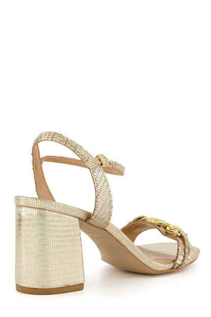 Gold heeled sandal with crisscross straps and gold logo ornament, block heel