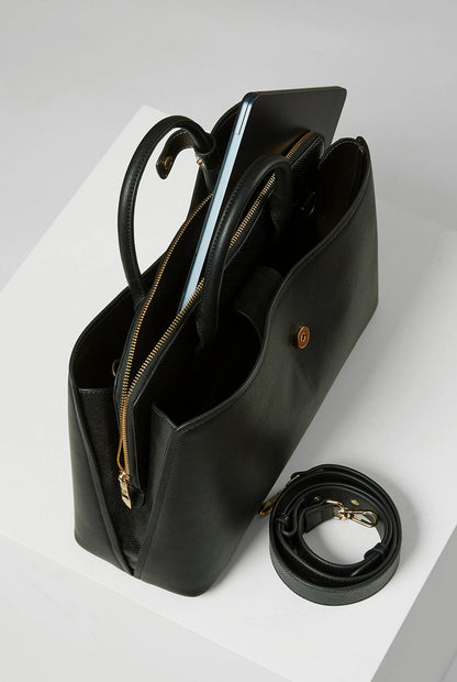 Black handbag with interior zip compartments and detachable crossbody strap, gold hardware