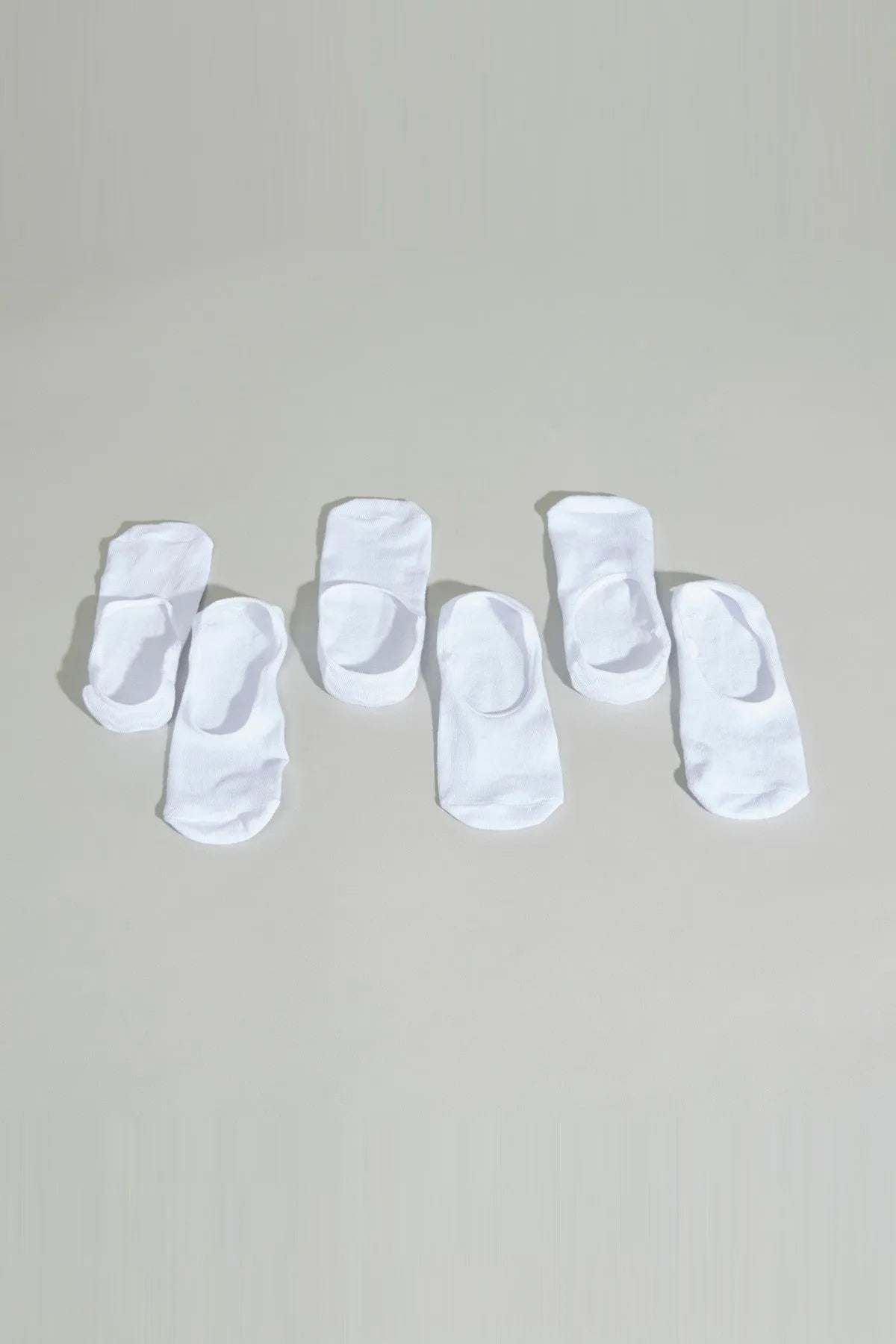 White baby socks, assortment of folded pairs with cuffs