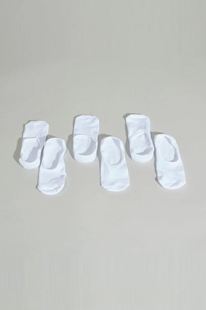 White baby socks, assortment of folded pairs with cuffs
