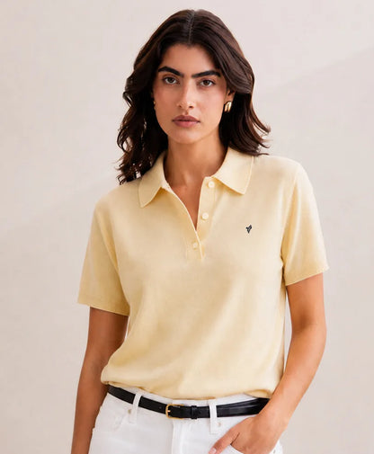 Cream polo shirt with short sleeves and button-down collar, small left-chest logo