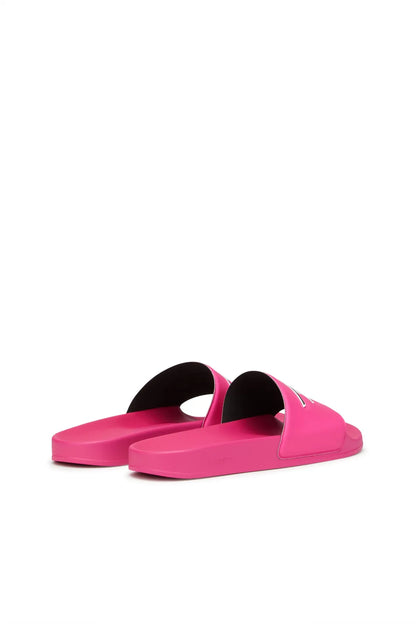 Pink slide sandals pair with dark interior