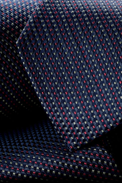 Charles Tyrwhitt necktie close-up, navy weave with red dots and white stripes