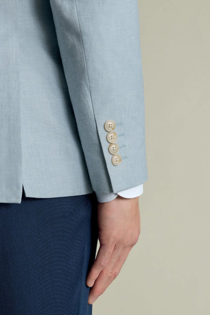 Light blue blazer sleeve cuff with three brown buttons and light shirt hem