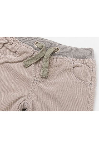 Beige baby trousers close-up: drawstring and front pocket details