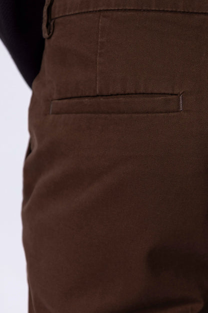 Men's brown chinos, close-up of back pocket with stitched detail