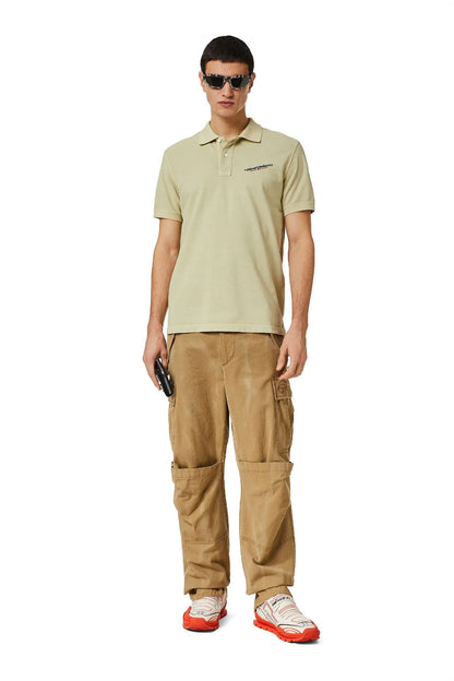 Light beige polo shirt worn with tan cargo pants; short sleeves and chest logo