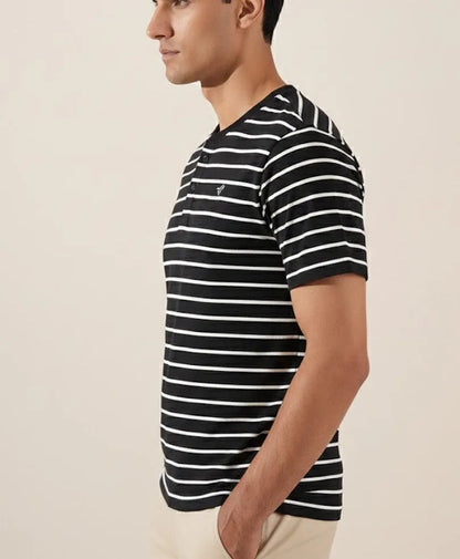 Fitted striped polo shirt side view, black with white horizontal stripes, short sleeves