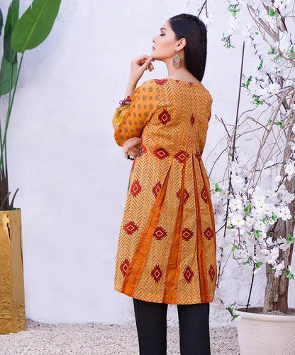 Orange patterned long-sleeve tunic dress with diamond motifs and flared skirt silhouette