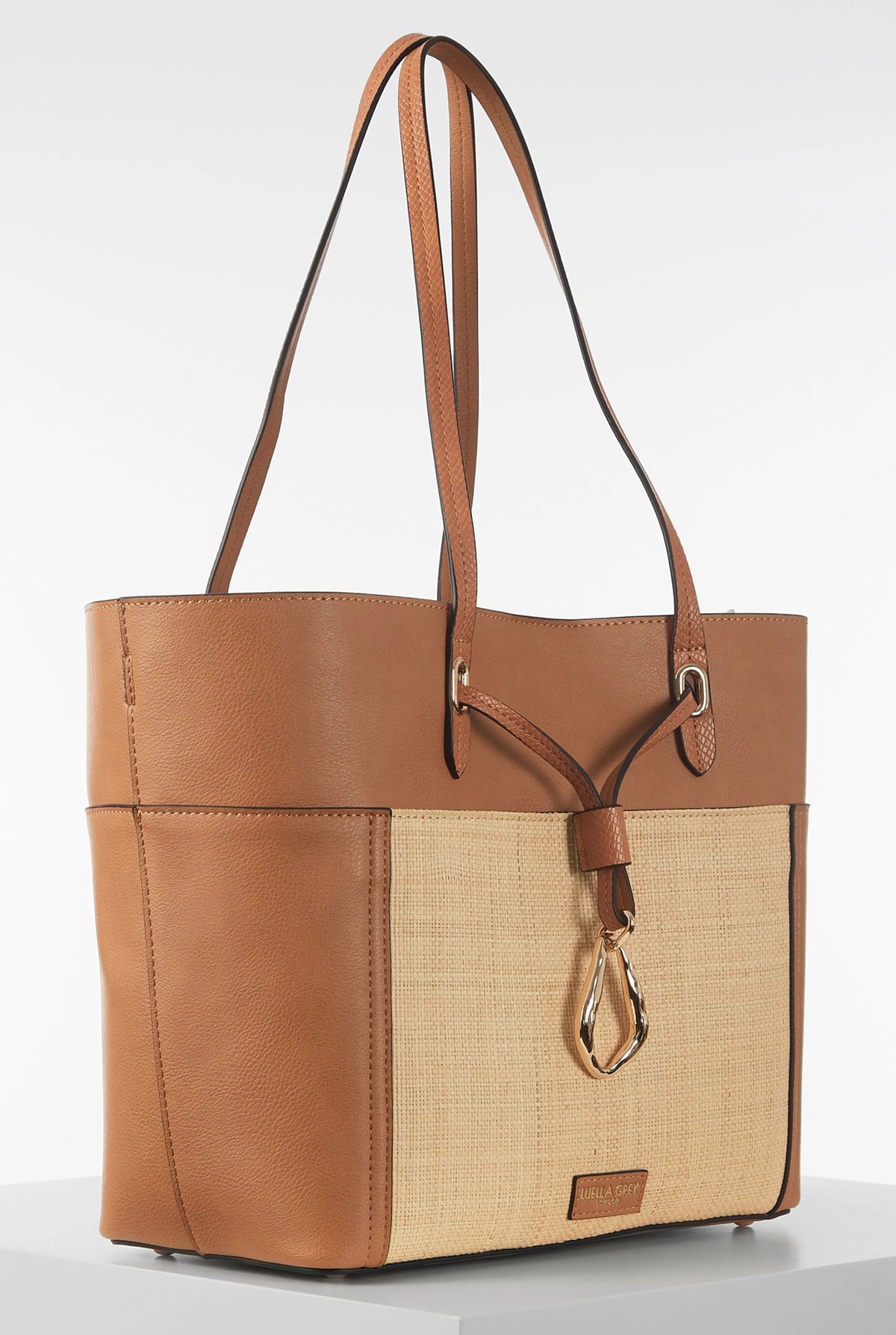 Brown leather-trim woven tote bag with two top handles and front pocket panel