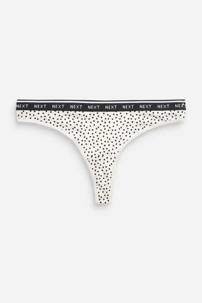 White thong with small black polka dots and branded waistband