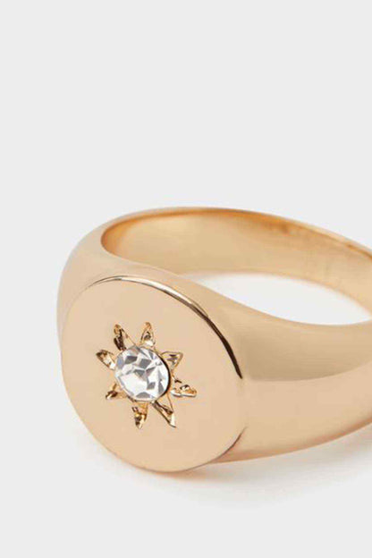 Accessorize gold-tone signet ring close-up with crystal starburst setting