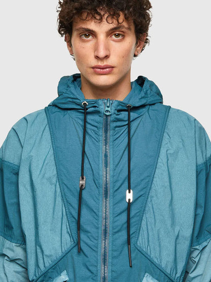 Men's teal hooded windbreaker jacket close-up with zip front and drawstrings