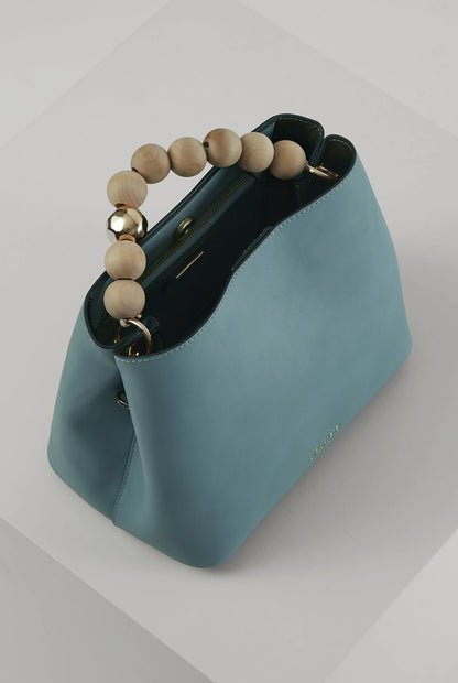 Teal handbag with wooden bead handle, leopard-trim crossbody strap, gold accents
