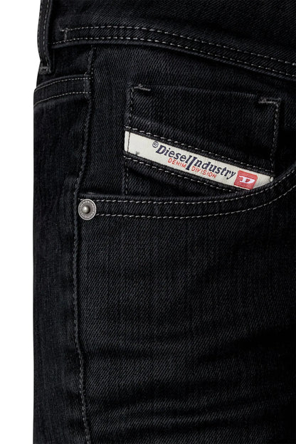 Black denim jeans pocket close-up with stitched seam and brand label