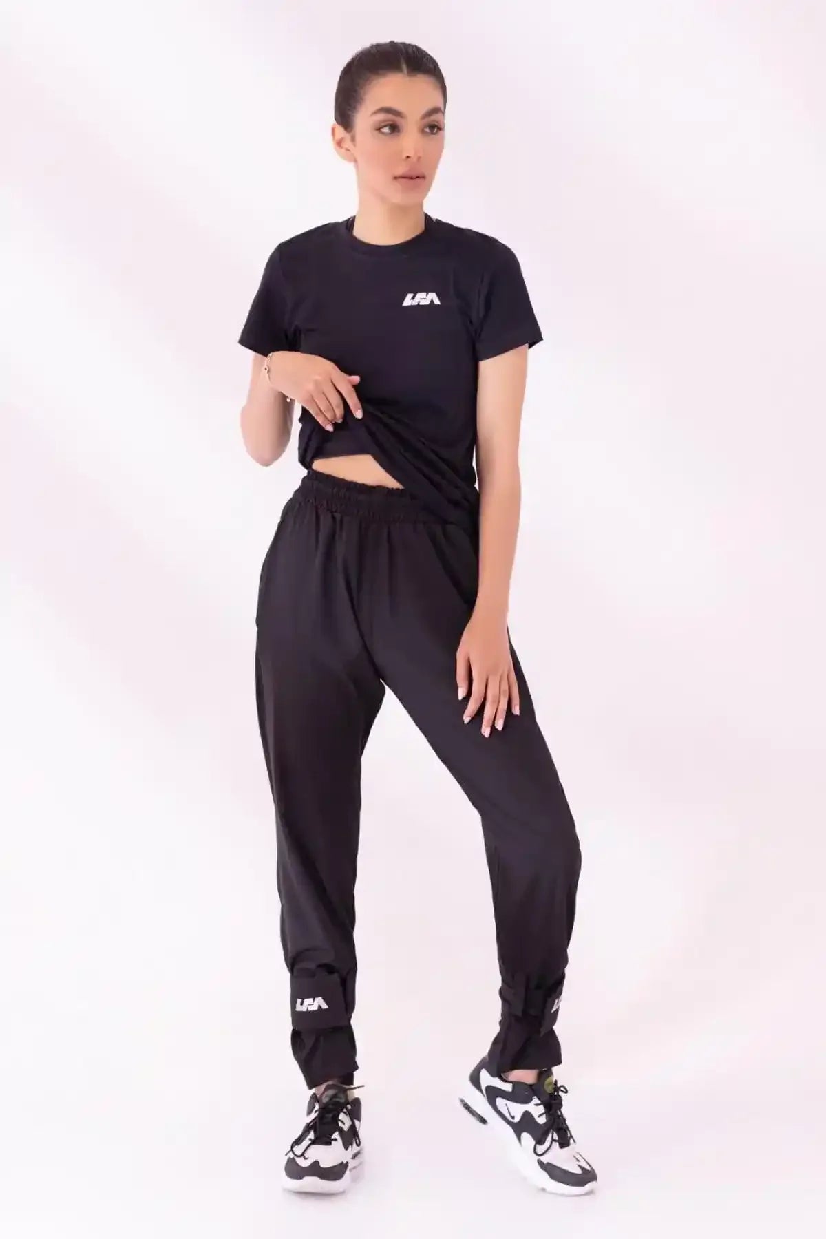 Black athletic joggers with elastic waist and ankle cuffs plus LFA chest logo top