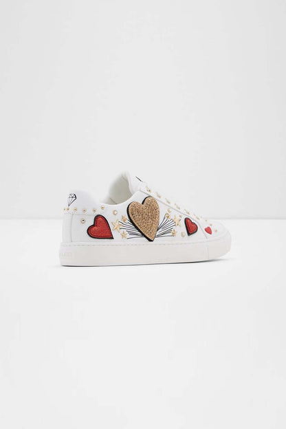 ALDO white low-top sneaker side view with heart and patch decorations