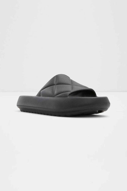 Black slide sandal with sculpted vamp and thick sole, front angle